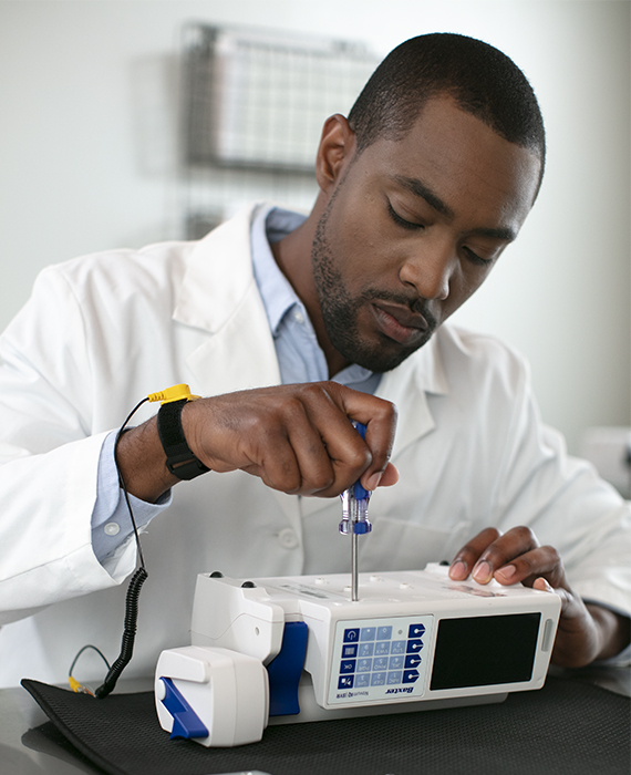 An engineer repairing an infusion pump.