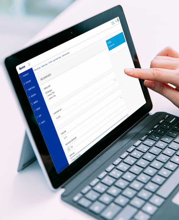 A tablet with a keyboard attached. A pharmacist builds a drug library on the screen of the tablet.