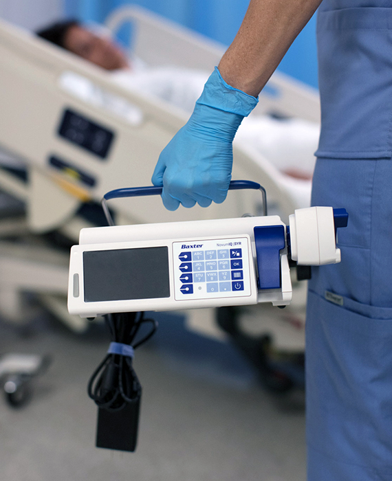 Medical professional holds infusion pump